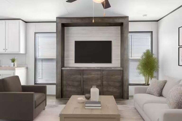 Modern living room with two gray sofas facing a wall-mounted TV above dark cabinetry and a wood coffee table.