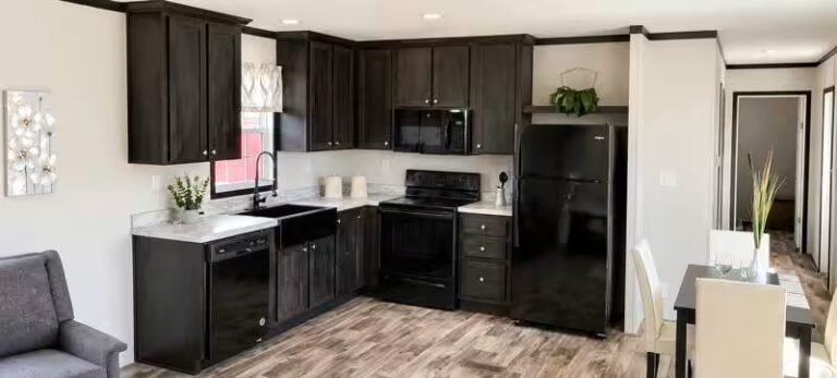 Modern kitchen with dark brown cabinets, black refrigerator, and tiled flooring; "OPEN" sign on door at right.