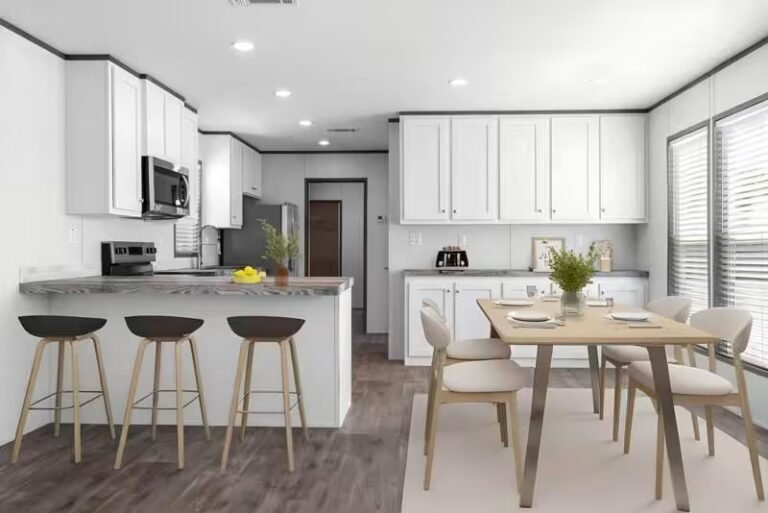 Modern white kitchen with breakfast bar, stools, dining table, beige chairs and wood-look floors